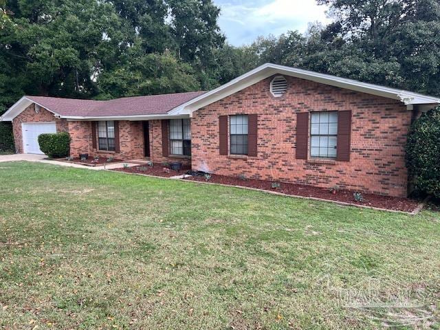 single story home with a front yard and a garage