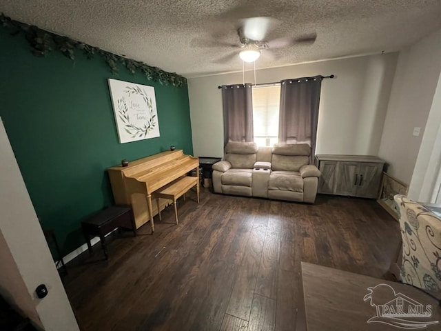 unfurnished living room featuring a textured ceiling, ceiling fan, and dark hardwood / wood-style floors