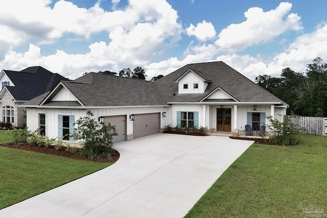 view of front of house featuring board and batten siding, driveway, french doors, a front lawn, and an attached garage