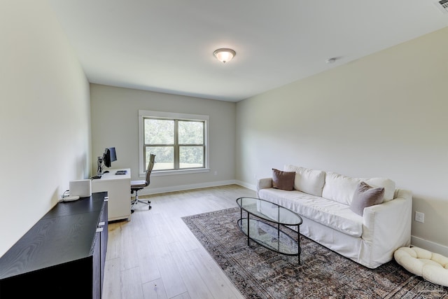office space with light wood-style floors and baseboards