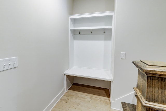mudroom with baseboards and wood finished floors