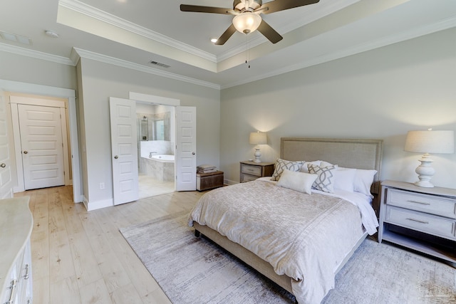 bedroom with a raised ceiling, ornamental molding, baseboards, and visible vents