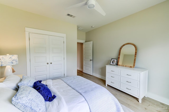 bedroom with a ceiling fan, baseboards, light wood-type flooring, visible vents, and a closet