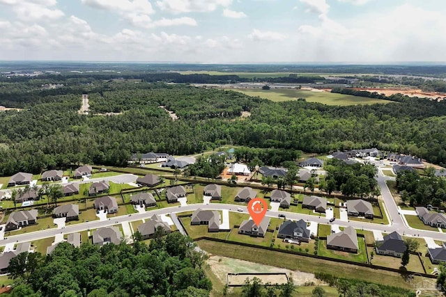 birds eye view of property featuring a residential view and a wooded view