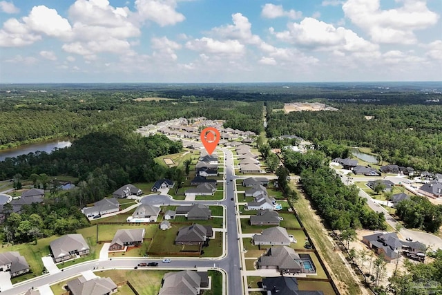 bird's eye view with a water view, a view of trees, and a residential view