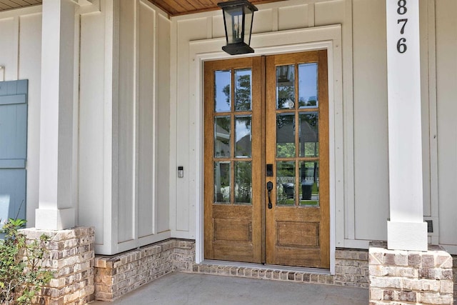 entrance to property featuring board and batten siding and french doors