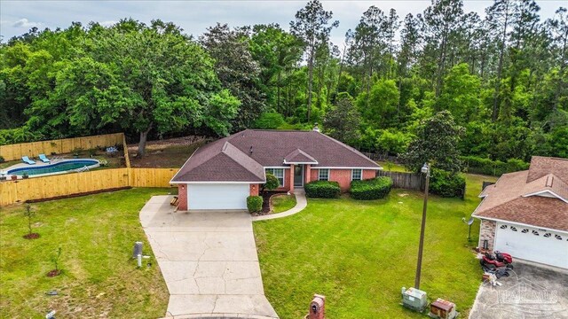 ranch-style home featuring concrete driveway, fence private yard, and a front yard