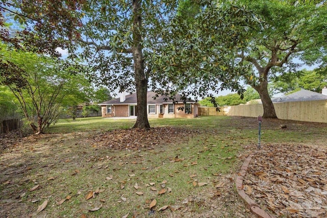 view of yard with a fenced backyard