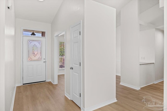foyer featuring baseboards and light wood-type flooring