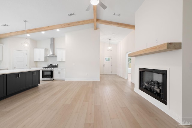 unfurnished living room featuring ceiling fan, light hardwood / wood-style flooring, high vaulted ceiling, and beamed ceiling