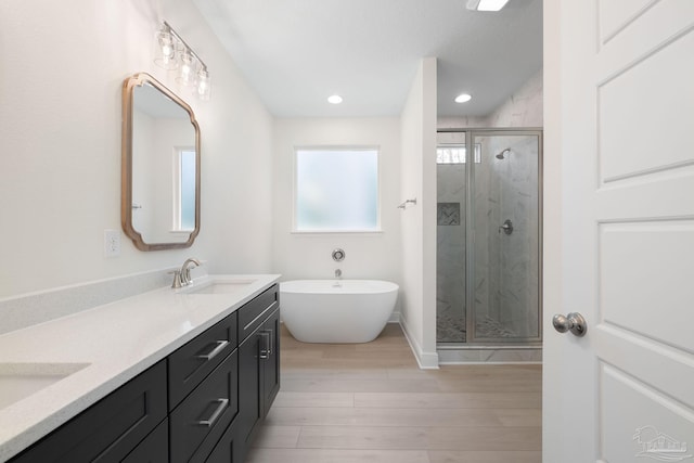 bathroom featuring vanity, independent shower and bath, and hardwood / wood-style floors