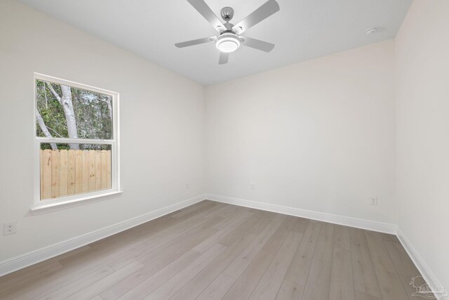 empty room featuring ceiling fan and light hardwood / wood-style flooring