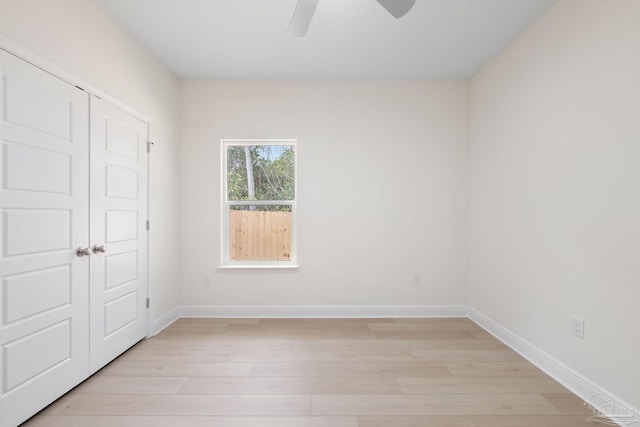 unfurnished room featuring ceiling fan, light hardwood / wood-style floors, and a closet