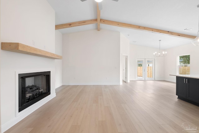 unfurnished living room featuring french doors, ceiling fan, light hardwood / wood-style flooring, and vaulted ceiling with beams