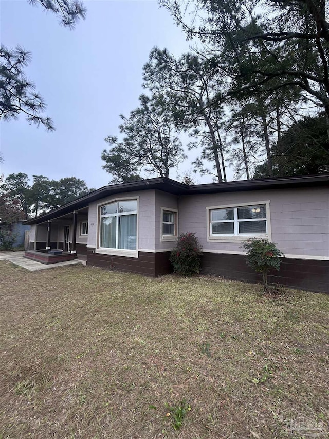 view of side of property with a yard