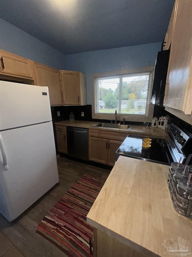 kitchen with sink, stainless steel electric range oven, black dishwasher, light brown cabinetry, and white fridge