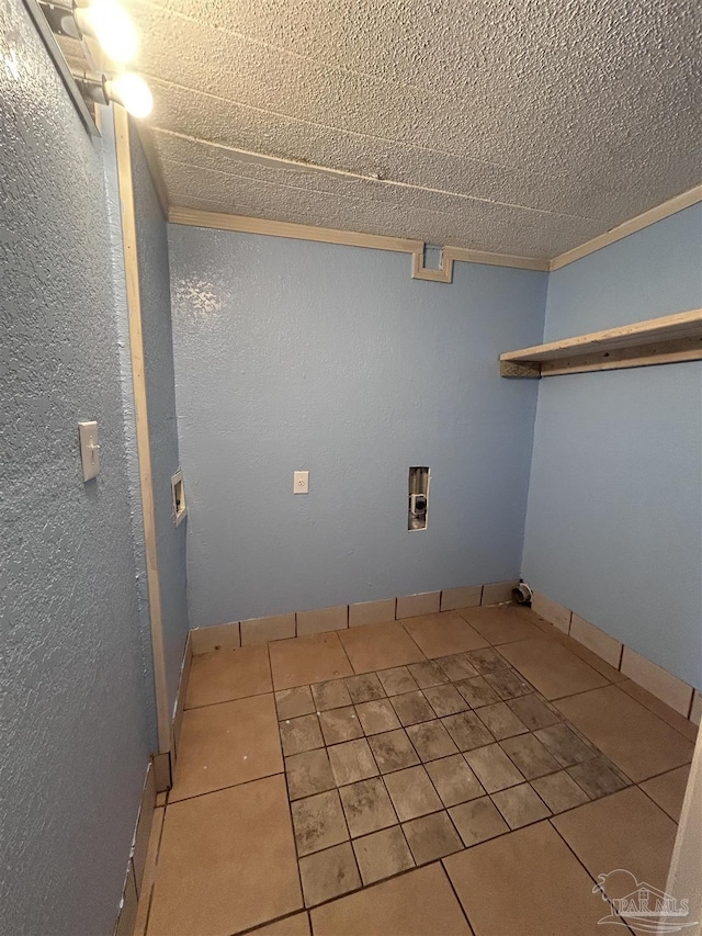 laundry area with light tile patterned floors, a textured ceiling, and hookup for a washing machine