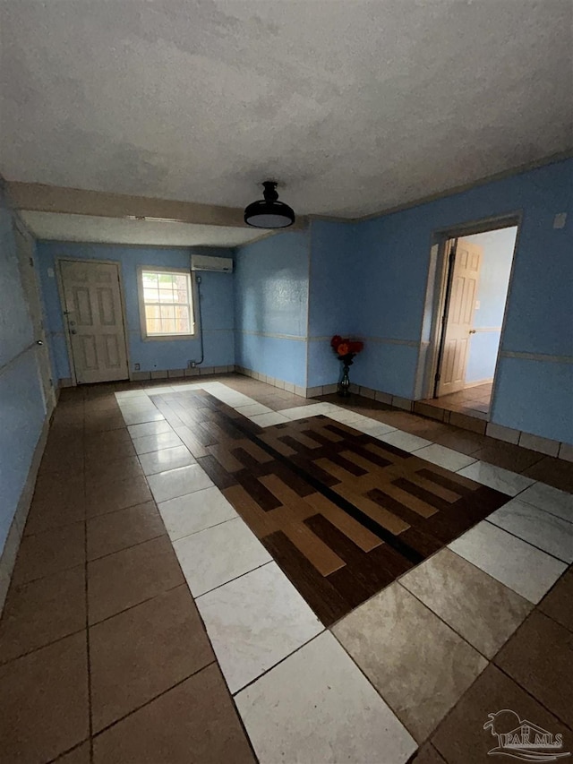 tiled spare room with a textured ceiling