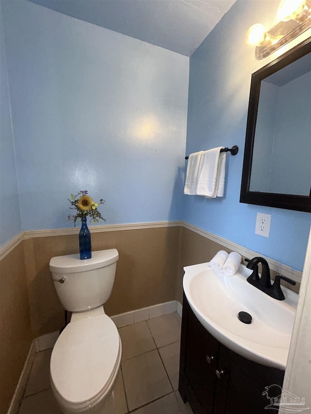 bathroom with tile patterned flooring, vanity, and toilet