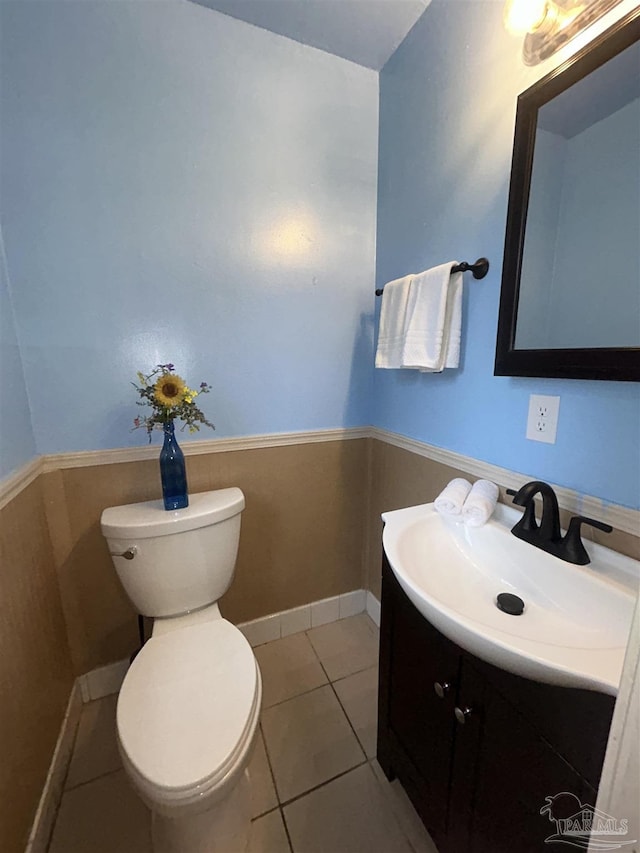 bathroom featuring tile patterned floors, vanity, and toilet