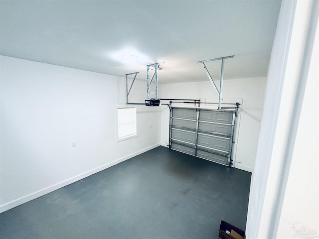 garage with baseboards and a garage door opener