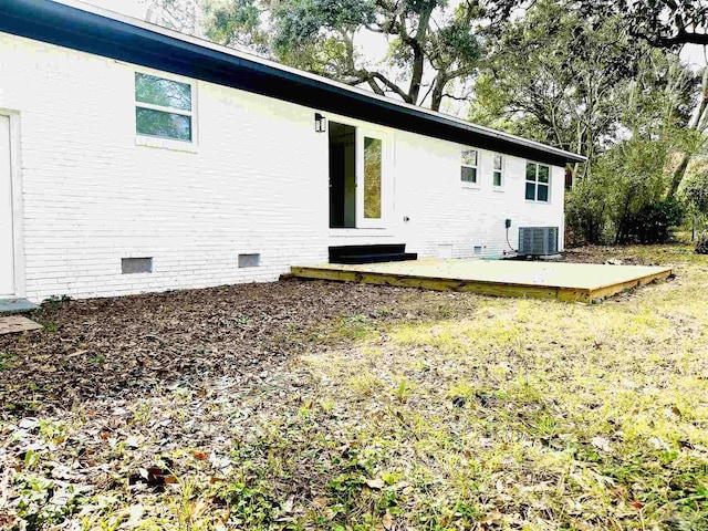 rear view of property with crawl space and cooling unit