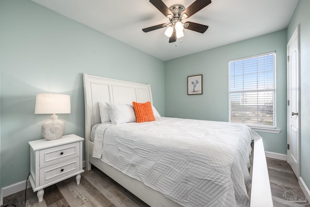 bedroom with ceiling fan, baseboards, and wood finished floors