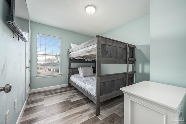 bedroom featuring light wood-type flooring and baseboards