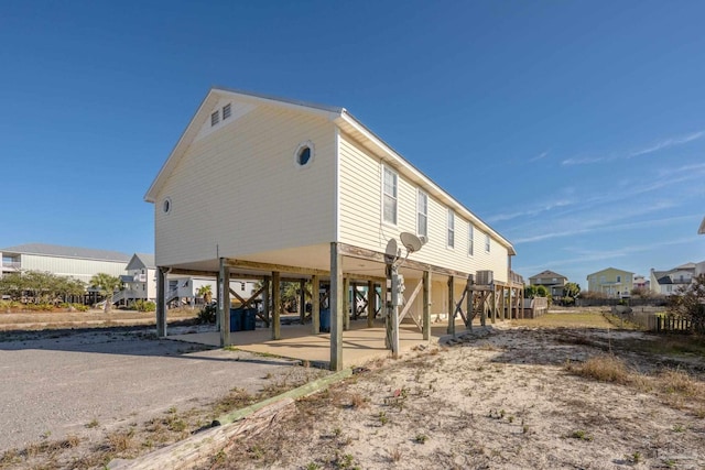 exterior space featuring dirt driveway, stairway, and a carport