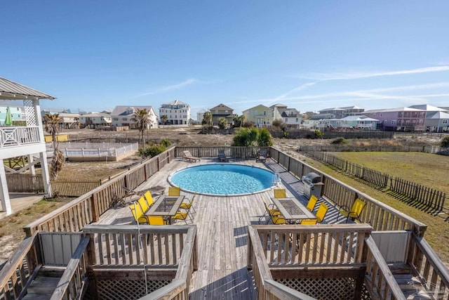 view of swimming pool featuring a fenced in pool and a wooden deck