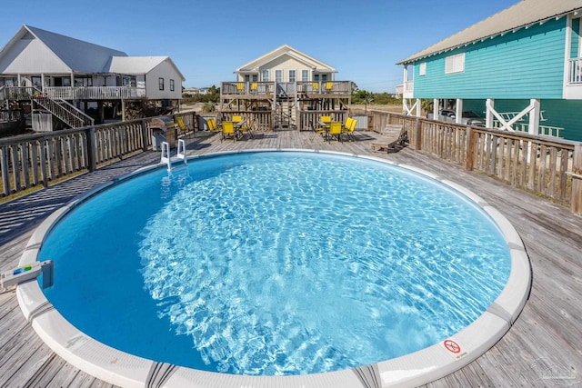 view of swimming pool with a deck and a fenced in pool