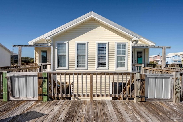 back of house with a wooden deck