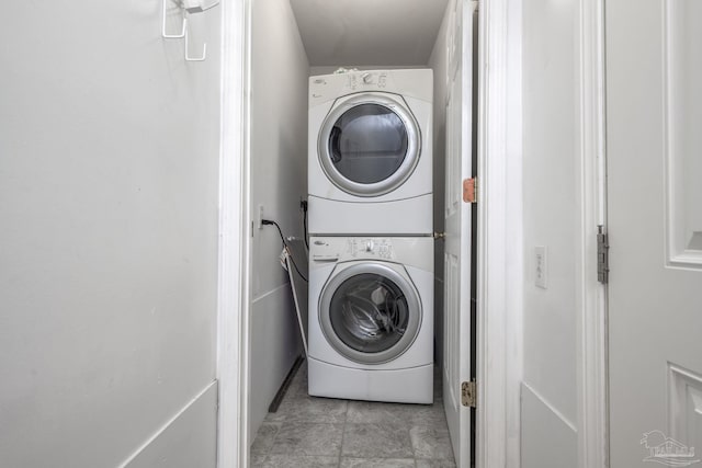 clothes washing area with laundry area and stacked washer / dryer