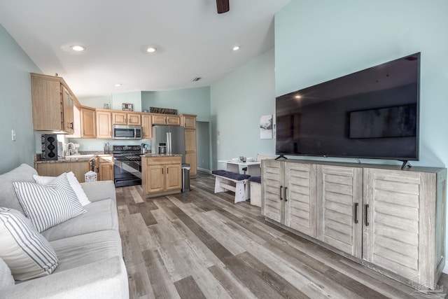 living room with light wood-type flooring, high vaulted ceiling, and recessed lighting