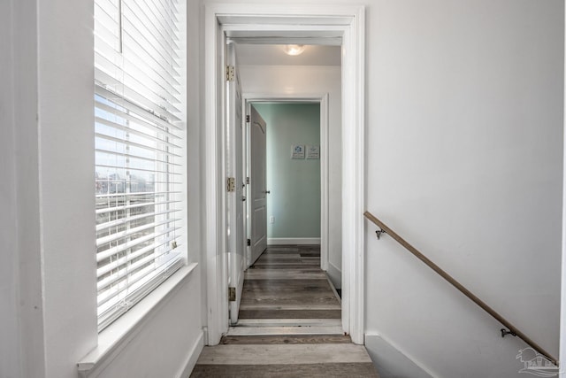 stairs with wood finished floors and baseboards