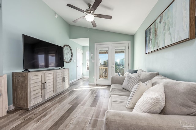 living room featuring wood finished floors, a ceiling fan, baseboards, vaulted ceiling, and french doors