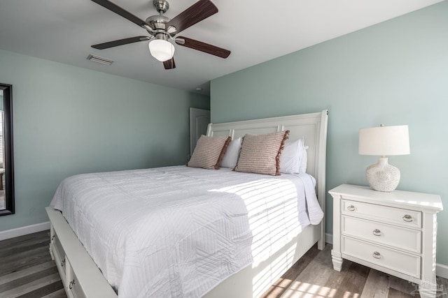 bedroom with baseboards, visible vents, ceiling fan, and dark wood-style flooring