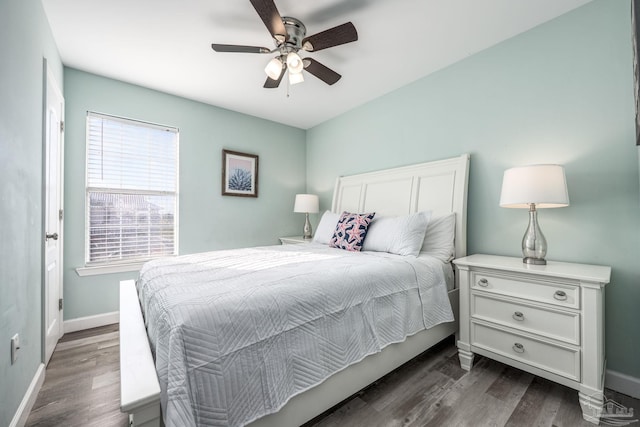 bedroom with dark wood-style floors, baseboards, and a ceiling fan