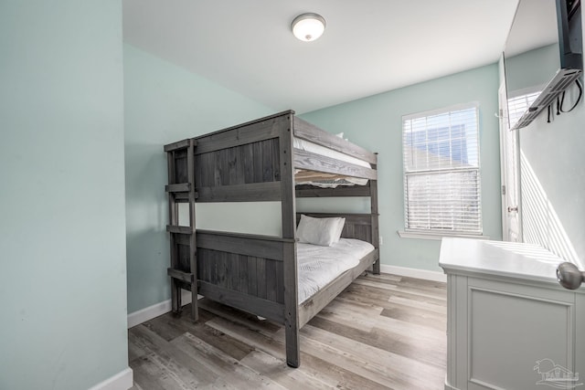 bedroom featuring light wood-style flooring and baseboards