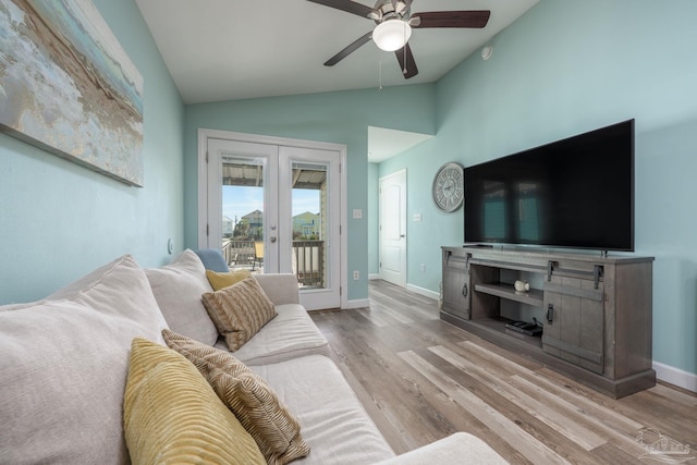 living room with lofted ceiling, baseboards, wood finished floors, and french doors