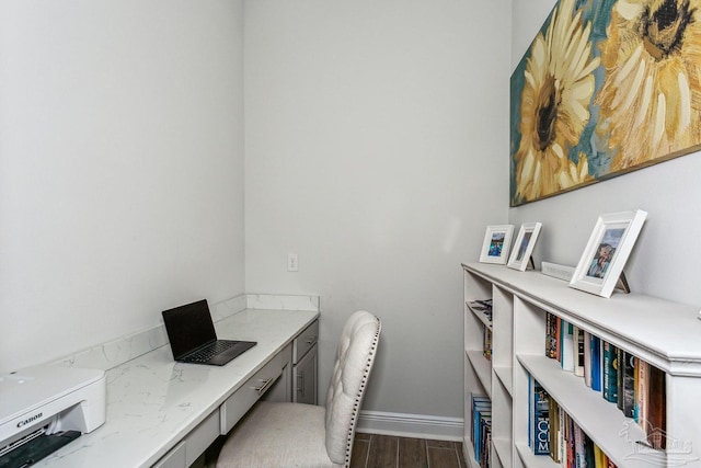 home office featuring baseboards and wood finished floors