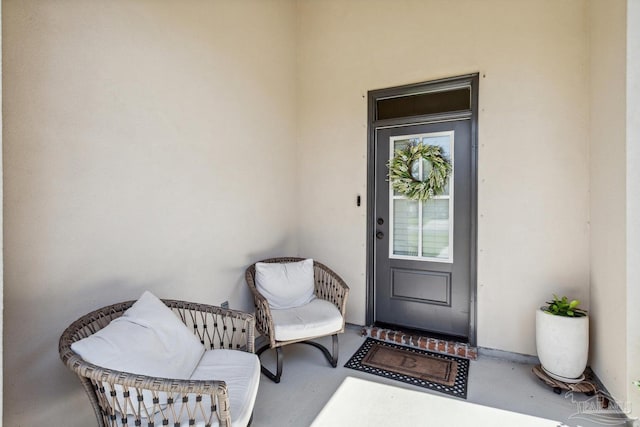 property entrance with stucco siding