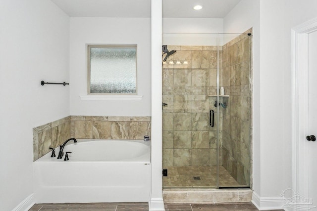 bathroom featuring a shower stall and a garden tub