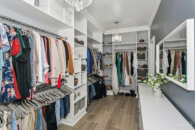 spacious closet featuring a chandelier and wood finished floors
