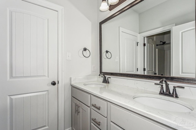 bathroom featuring a sink and double vanity