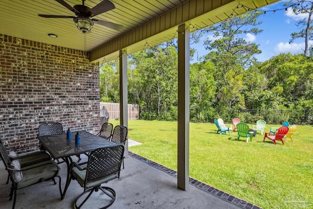 view of patio / terrace with outdoor dining area, ceiling fan, and fence