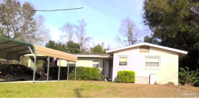 4530 Florelle Way, Pensacola, FL 32505 - rear view of house featuring a detached carport and a lawn