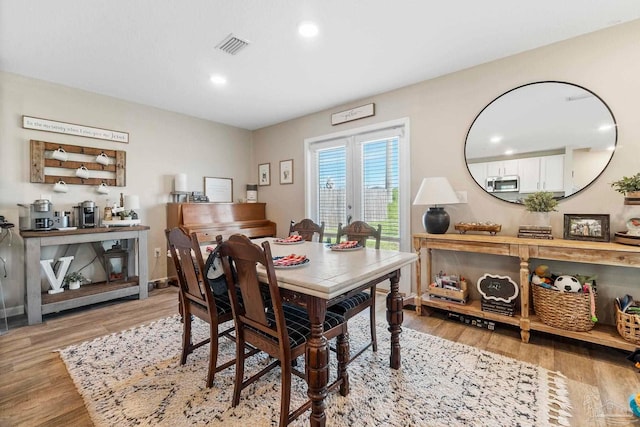 dining area with baseboards, visible vents, french doors, light wood-style floors, and recessed lighting