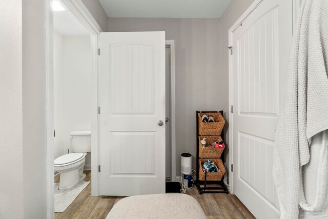 bathroom with wood-type flooring and toilet