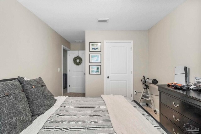 bedroom with light colored carpet